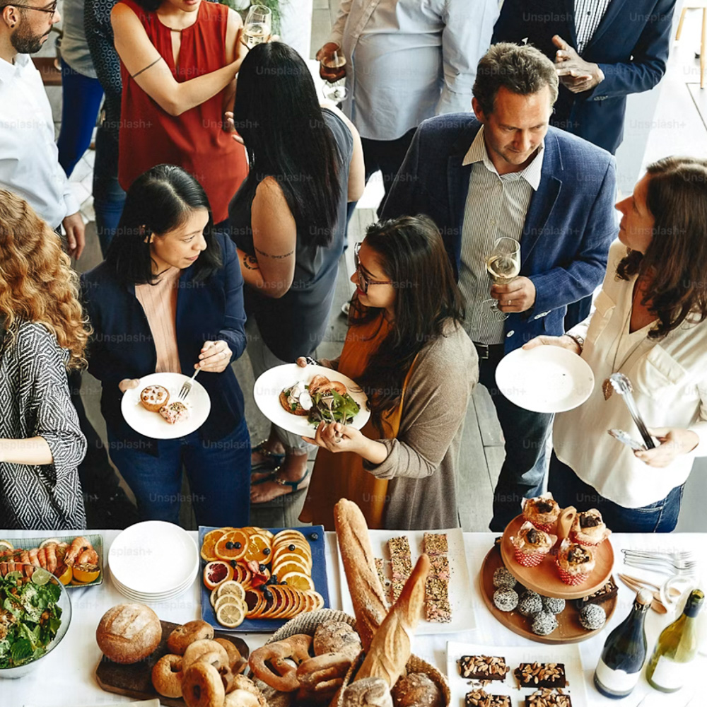 Guests sharing a family-style spread at a Café de Olla catered event